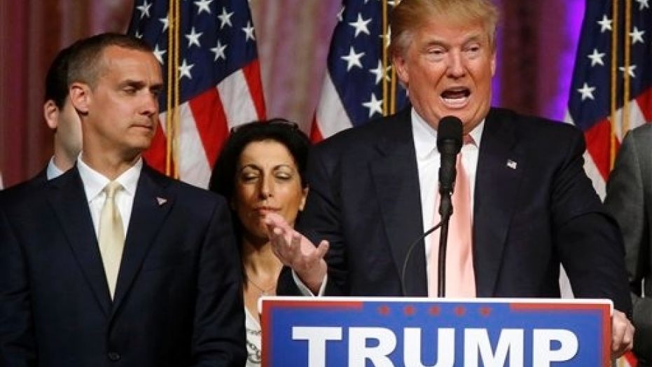 Corey Lewandowski, left, appears onstage as then-candidate Donald Trump speaks in Palm Beach, Fla., March 15, 2016.