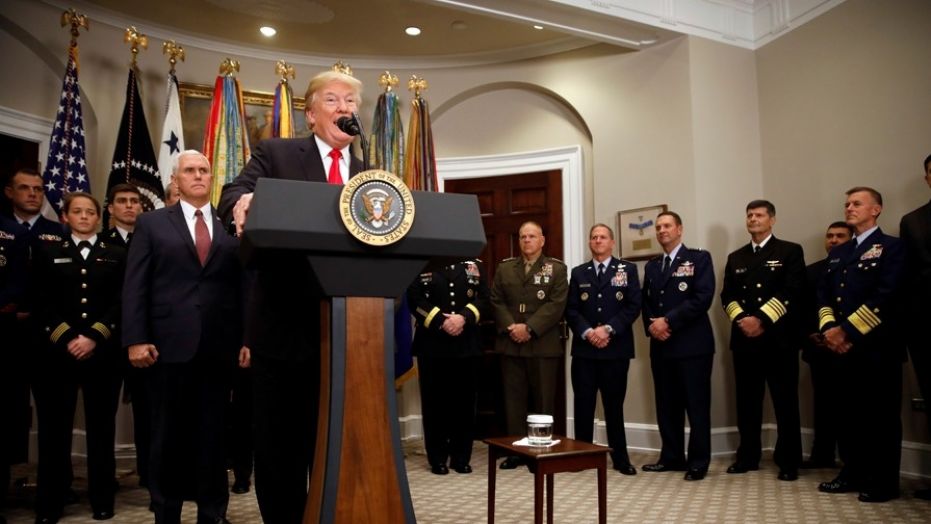 U.S. President Donald Trump speaks during the signing ceremony of the National Defense Authorization Act for Fiscal Year 2018, accompanied by Vice President Mike Pence and members of the military, at the White House in Washington D.C., U.S. December 12, 2017. REUTERS/Carlos Barria - RC1D3923A330