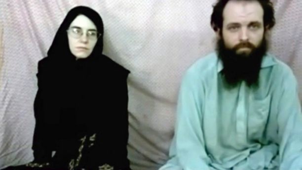 This still image made from a 2013 video released by the Coleman family shows Caitlan Coleman and her husband, Canadian Joshua Boyle in a militant video given to the family. The American woman, her Canadian husband and their three young children have been released in October 2017 after years of being held captive by a network with ties to the Taliban. The two were abducted five years ago while traveling in Afghanistan and have been held by the Haqqani network. The couple had three children while in captivity. (Coleman family via AP)