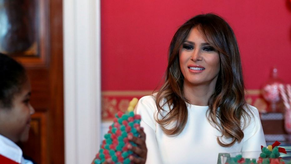 First lady Melania Trump visits with children in the Red Room working on holiday treats among the 2017 holiday decorations with the theme "Time-Honored Traditions" at the White House in Washington, Monday, Nov. 27, 2017. The First Lady honored 200 years of holiday traditions at the White House. 