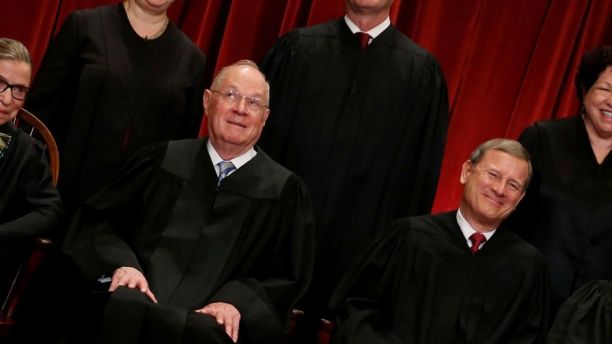 U.S. Supreme Court Justice Anthony Kennedy (L) reacts while chatting with Chief Justice John Roberts (R) during a new U.S. Supreme Court family photo including Justice Neil Gorsuch (not pictured), their most recent addition, at the Supreme Court building in Washington, U.S. June 1, 2017.  REUTERS/Jonathan Ernst - RC11BC0F6480