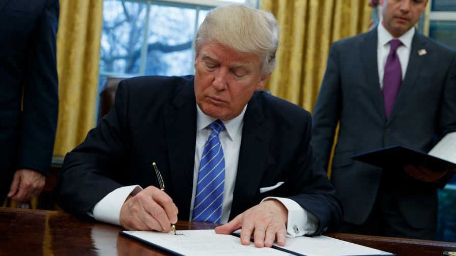 President fulfills campaign pledge on the Trans-Pacific Partnership trade deal; additionally signs order placing hiring freeze on some federal workers, reinstate ban on providing federal money to international groups that perform abortions