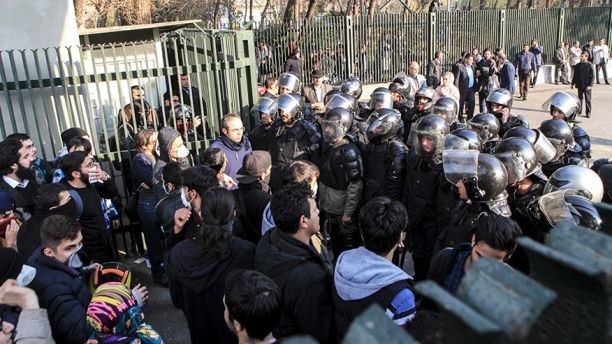 In this photo taken by an individual not employed by the Associated Press and obtained by the AP outside Iran, anti-riot Iranian police prevent university students to join other protesters over Iran weak economy, in Tehran, Iran, Saturday, Dec. 30, 2017. A wave of spontaneous protests over Iran's weak economy swept into Tehran on Saturday, with college students and others chanting against the government just hours after hard-liners held their own rally in support of the Islamic Republic's clerical establishment. (AP Photo)