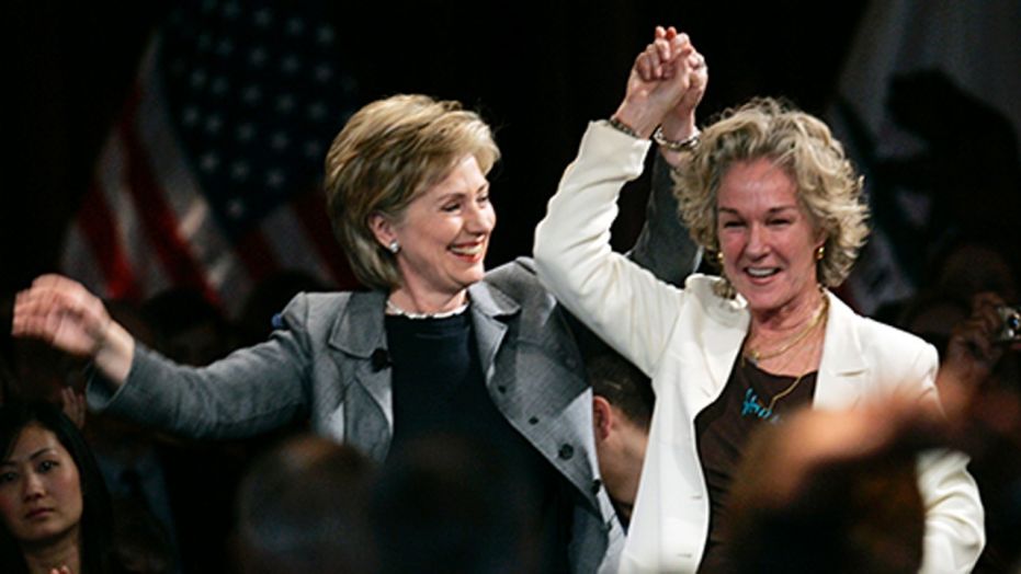 Image captured Hillary Clinton holdings hands with close friend and Esprit Clothing founder Susie Tompkins Buell.