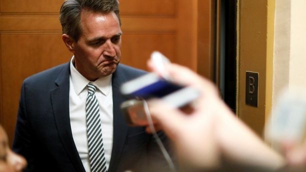 U.S. Senator Jeff Flake (R-AZ) talks to reporters as he arrives for the weekly Republican party caucus luncheon at the U.S. Capitol in Washington, U.S. October 31, 2017.  REUTERS/Jonathan Ernst - RC1EF7963D60