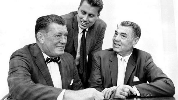 FILE - In this Sept. 23, 1964 file photo, boxing heavyweights Gene Tunney, left, and Jack Dempsey, right, pose with Tunney's son, John V. Tunney, at a news conference in Los Angeles. John Tunney, the former U.S. senator from California, has died. His brother Jay Tunney says John Tunney died Friday, Jan. 12, 2018 in Santa Monica, Calif., of cancer. He was 83. John Tunney was the son of heavyweight boxing champion Gene Tunney, and was among the youngest people elected to the U.S. Senate in the past century when he won his seat in 1970 at age 36. (AP Photo, File)