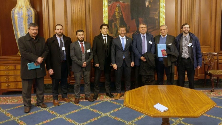 Members of the Free Syrian Army delegation pose with Rep. Adam Kinzinger, R-Ill. (fourth from right)